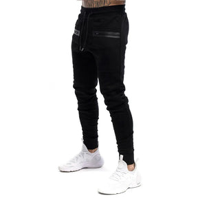 Calça de moletom fitness masculina, confeccionada em algodão premium, com bolsos com zíper e cintura ajustável. Perfeita para treinos e conforto diário.